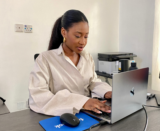 Chinny at her desk in a Comfortable Work from home dress 