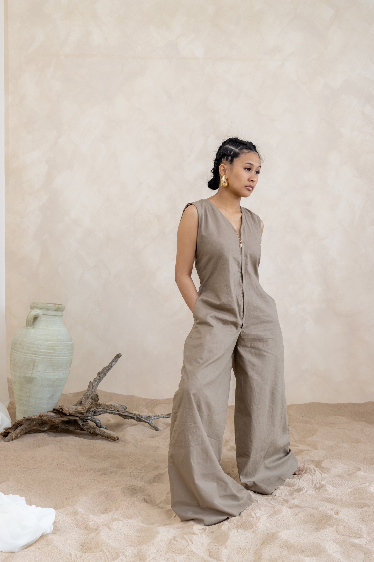 Summer vacation-inspired jumpsuit by 1964 brand, featuring a flattering silhouette with wide-leg pants in a timeless earth tone hue."