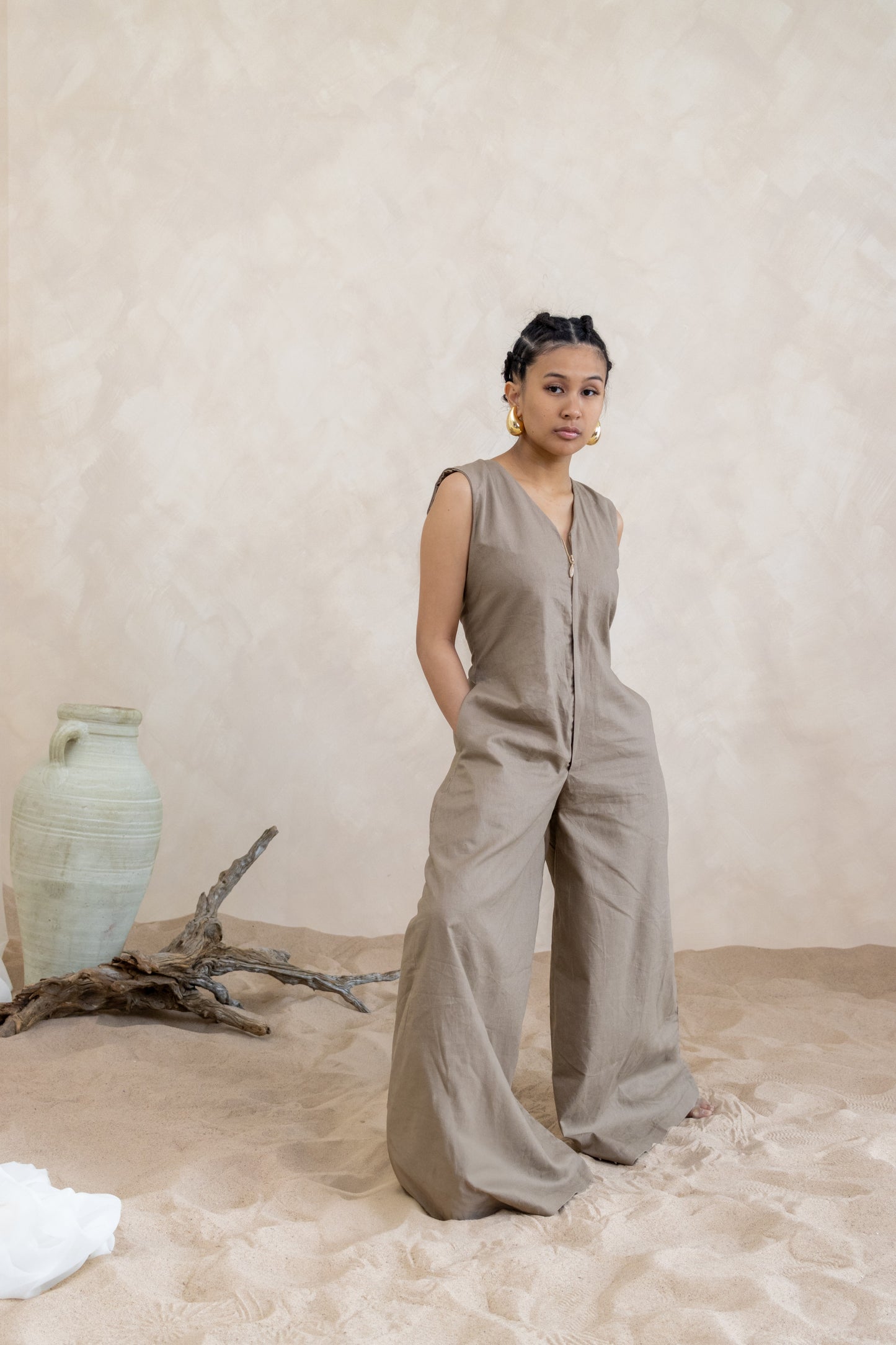 Summer vacation-inspired jumpsuit by 1964 brand, featuring a flattering silhouette with wide-leg pants in a timeless earth tone hue."